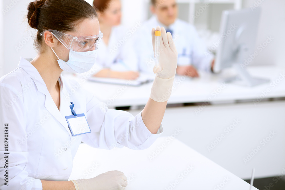 Scientific research team with clear solution in laboratory Scientific research team with clear solution in laboratory