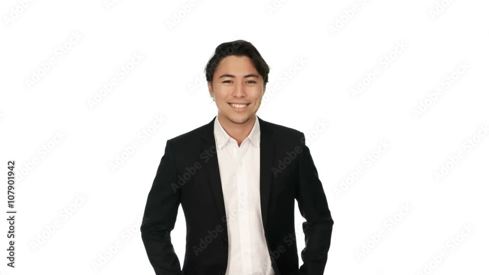 Adult businessman wearing a black suit and white shirt, standing against a white background with a big smile on his face. Video shot in 4K. Adult businessman wearing a black suit and white shirt, standing against a white background with a big smile on his face. Video shot in 4K.