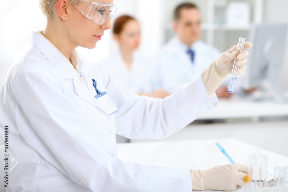 Scientific research team with clear solution in laboratory Scientific research team with clear solution in laboratory