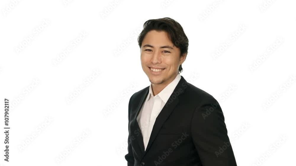Adult businessman wearing a black suit and white shirt, standing against a white background with a big smile on his face. Video shot in 4K. Adult businessman wearing a black suit and white shirt, standing against a white background with a big smile on his face. Video shot in 4K.