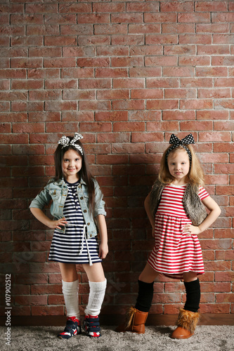 Two stylish little girls on...