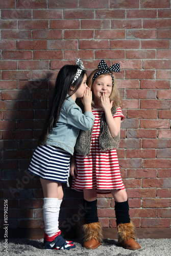 Two stylish little girls on...