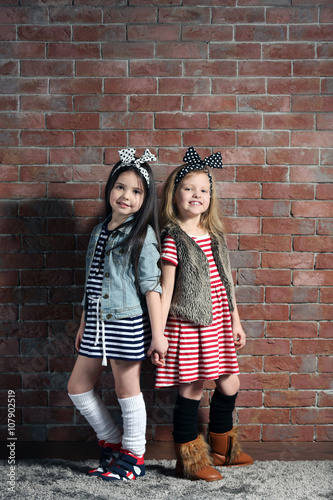 Two stylish little girls on...