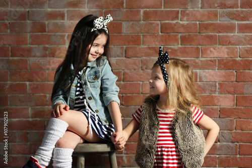 Two stylish little girls on...