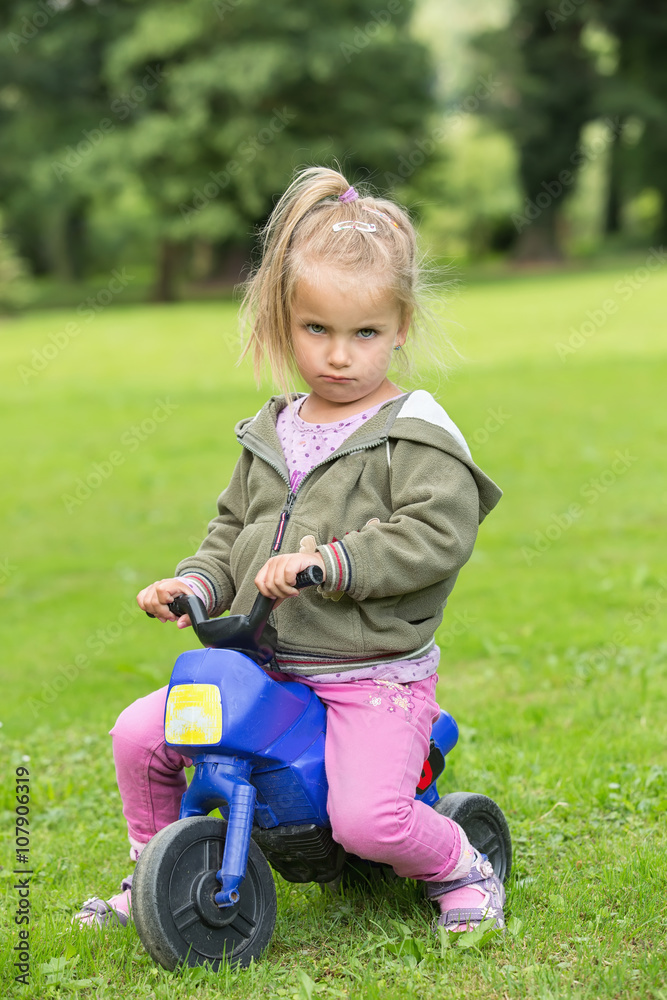 Girl sitting in the park on a motorbike Girl sitting in the park on a motorbike