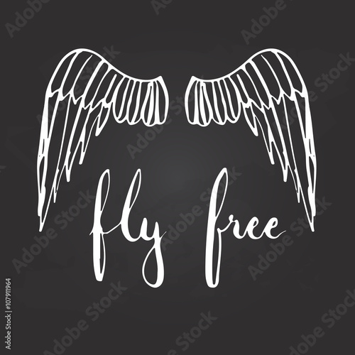 Hand drawn typography lettering phrase Fly free with birds wings on the black background.
