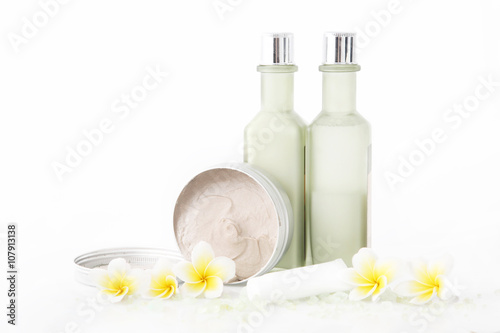 Set of different cosmetic product with frangipani flowers