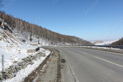 Mountain highway among snow slope , Belokurikha, Altai, Russia