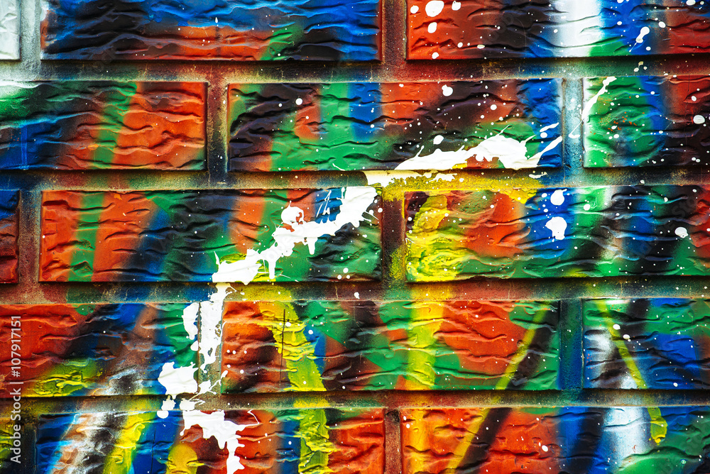 Colorful paint sprayed brick wall