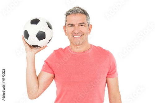 Happy football fan holding ball