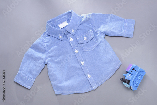 Single blue infant long sleeve shirt and toy