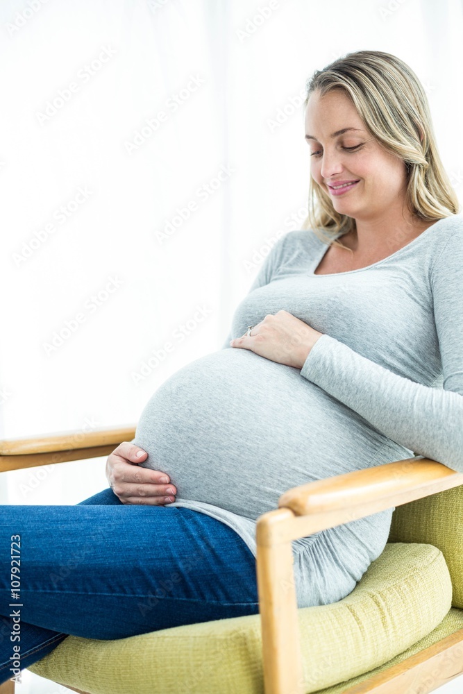 Pregnant woman holding her stomach Pregnant woman holding her stomach