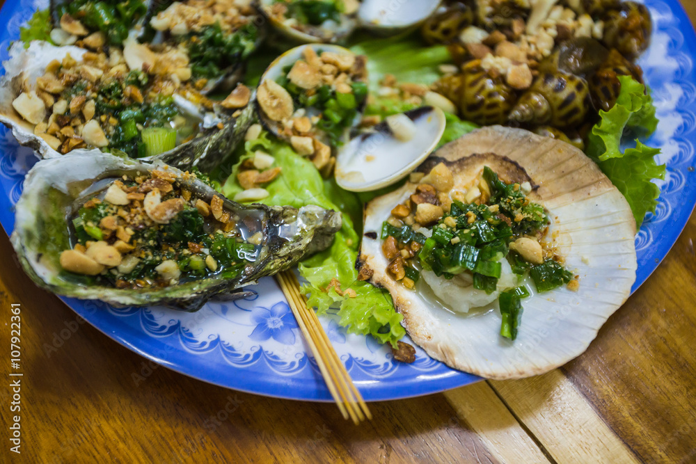 Fresh oysters in a  plate with spice and lemon