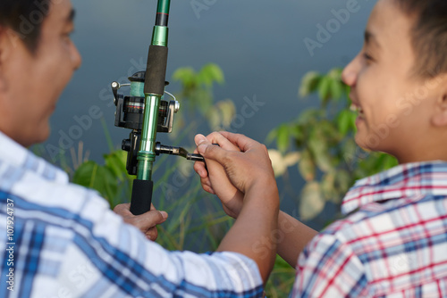 Father teaching his kid how to use rod