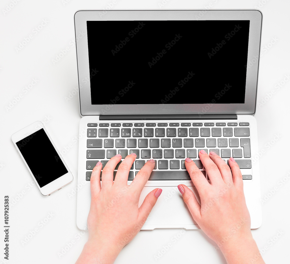 Female hands typing on the laptop keyboard Female hands typing on the laptop keyboard