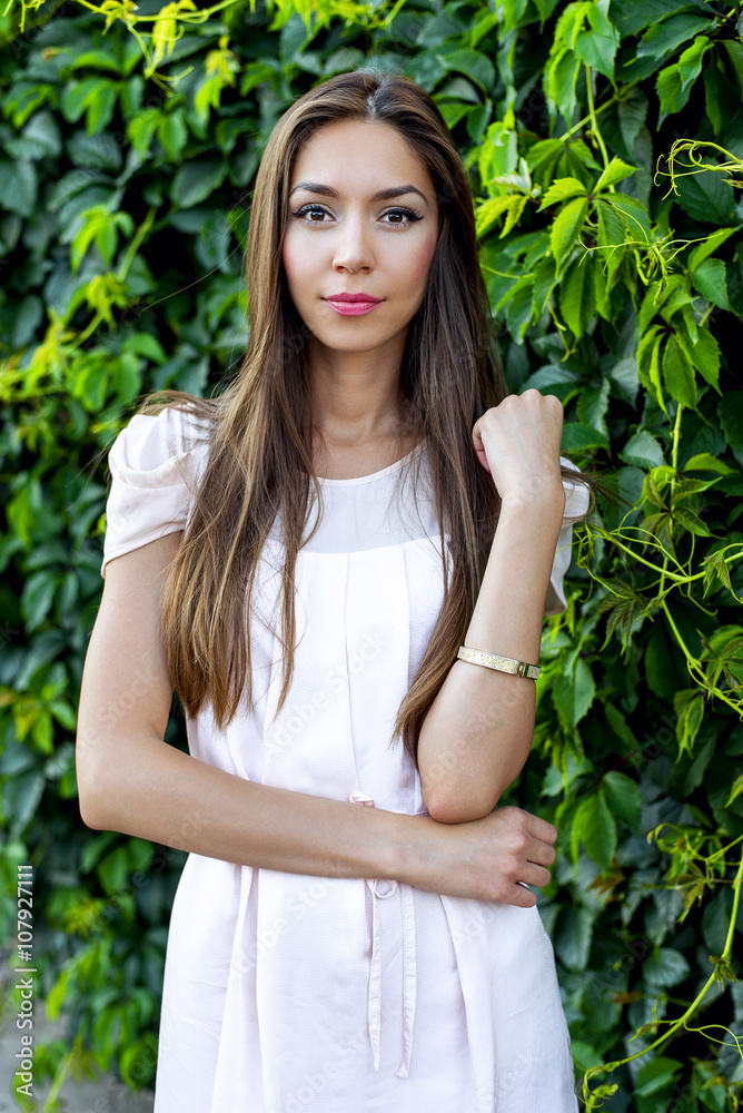 Beautiful brunette pink dress, standing on the street, a bright sunny day, fashion style, urban life, posing, looking tenderly. Beautiful brunette pink dress, standing on the street, a bright sunny day, fashion style, urban life, posing, looking tenderly.