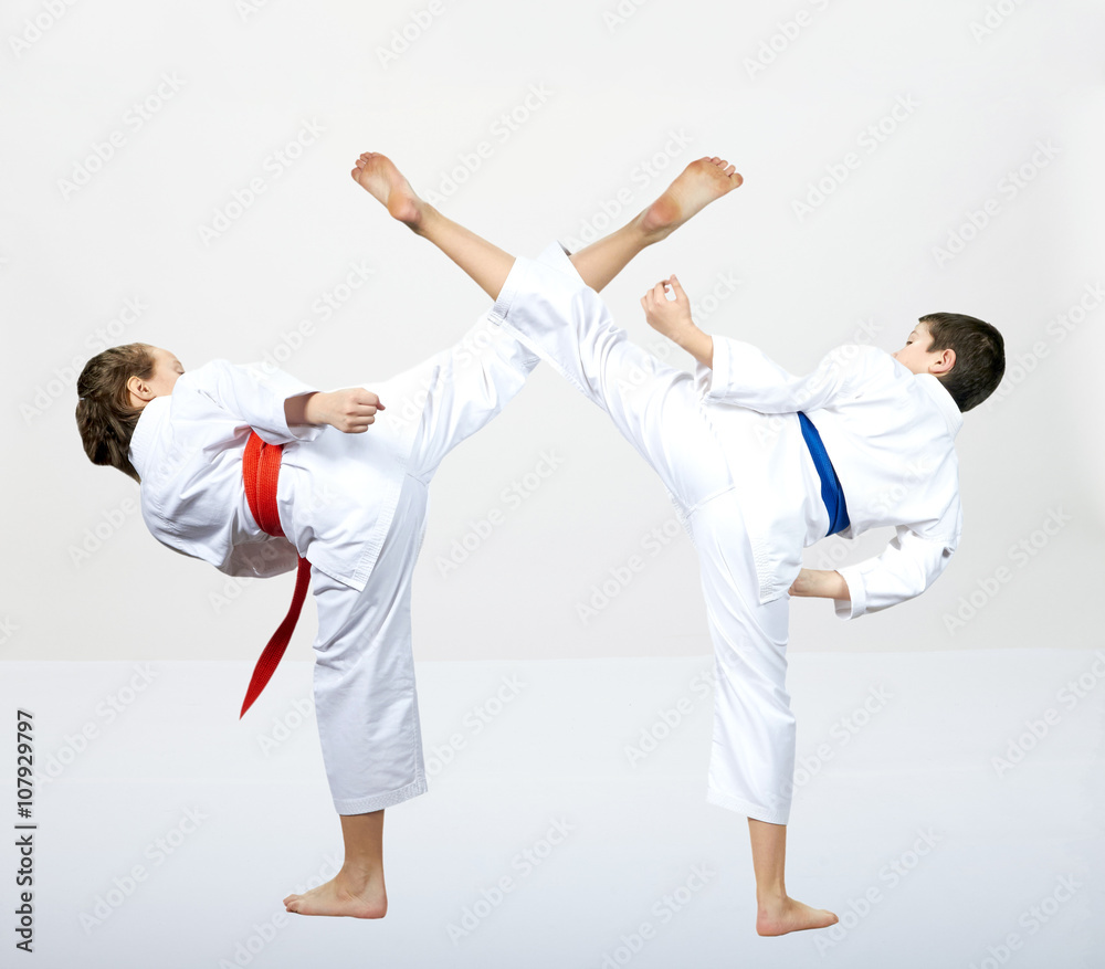 On a gray background athletes are beating kick leg