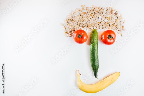 Happy face made with fresh fruits. Tomato, cucumber , banana, pu