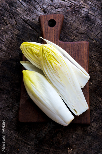 Fresh Chicory Salad  on  rustic wooden table.