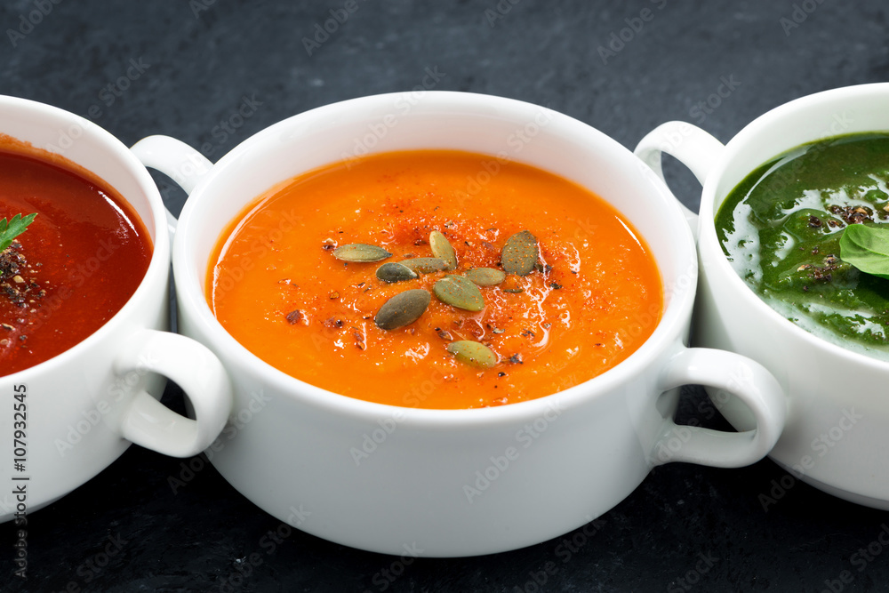 assortment of fresh vegetable soup on black background, closeup assortment of fresh vegetable soup on black background, closeup