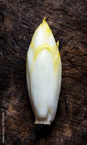 Fresh Chicory Salad  on  rustic wooden table.