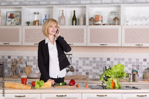 Business Lady cooking Food and talking on Telephone
