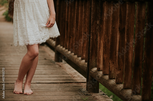 Close-up of a bare legs of a girl in the woods photo