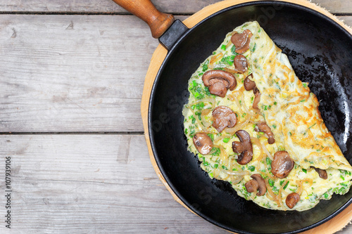 French omelet with herbs, stuffed with mushrooms and onions