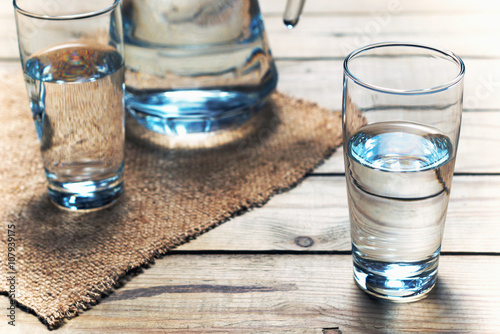 Glasses of water on wooden table. Selective focus.