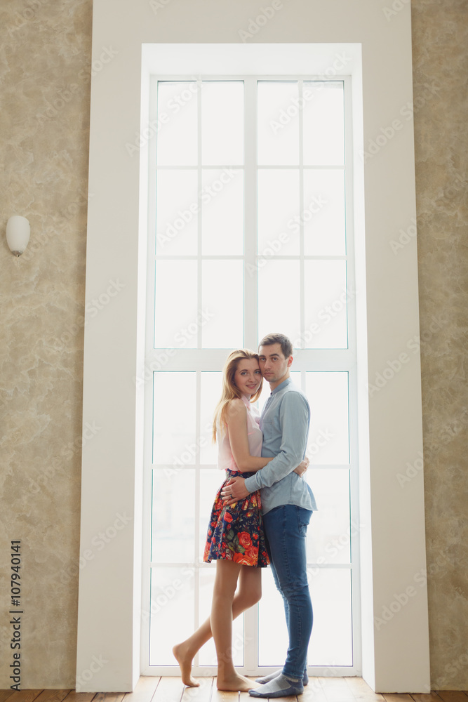 man and woman near a large window. man and woman near a large window.
