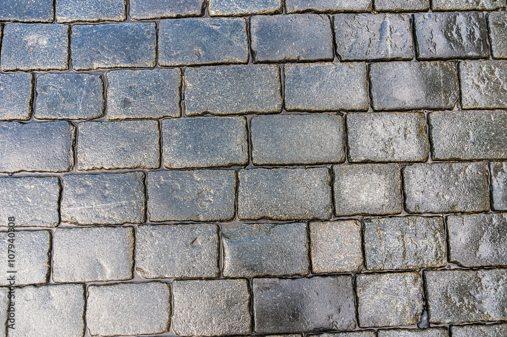 Grey cobblestone pavement after the rain