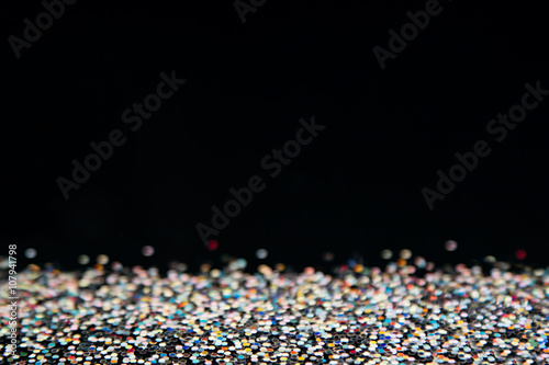 Shiny colorful multicolored background with black copy space. The texture.