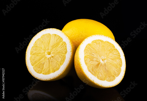 Lemons group isolated on black background