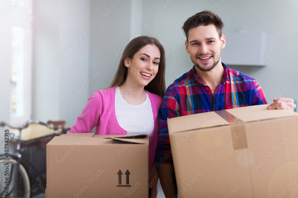 Couple with unpacked boxes in new home