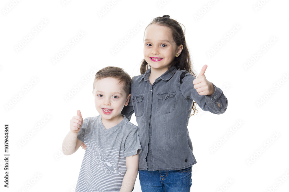 cute little boy and girl with his thumb up on the white background cute little boy and girl with his thumb up on the white background