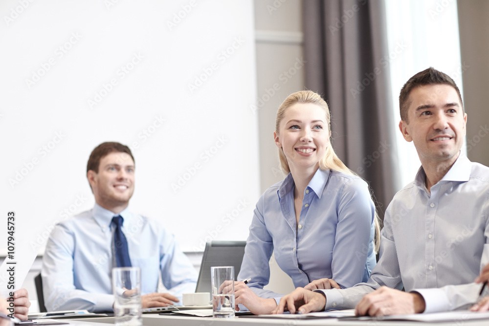 group of smiling businesspeople meeting in office group of smiling businesspeople meeting in office