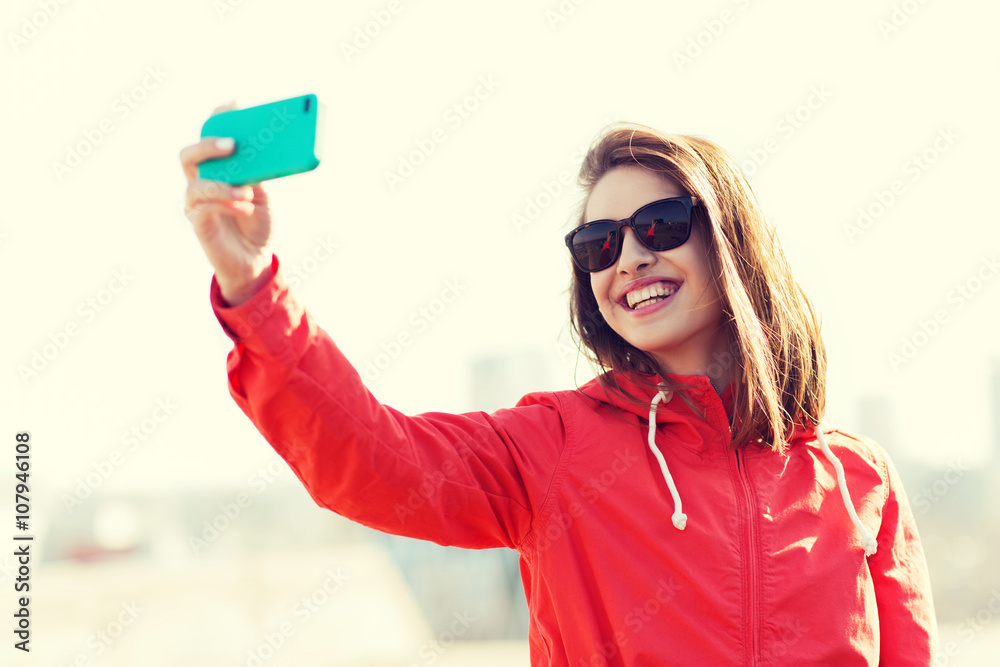 smiling young woman taking selfie with smartphone smiling young woman taking selfie with smartphone