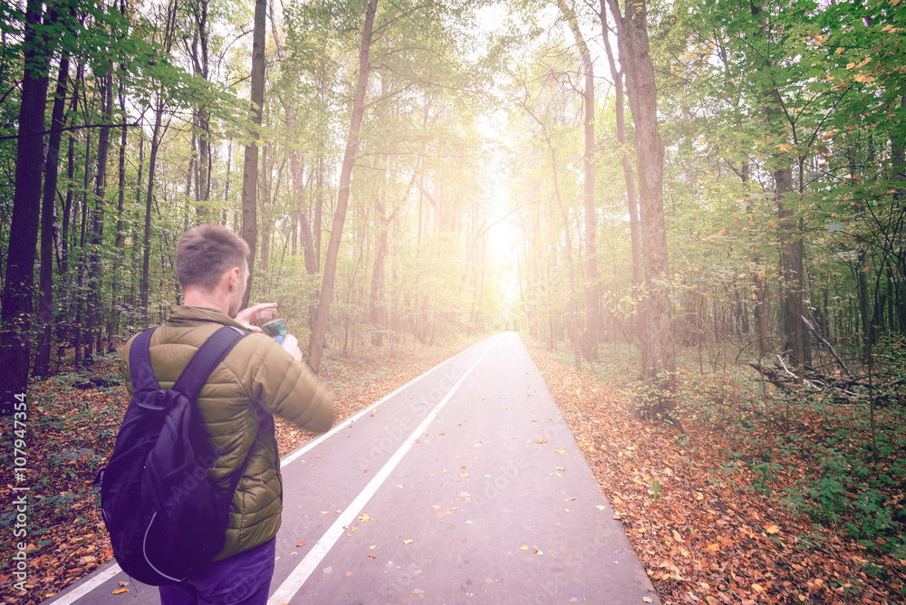 Fototapeta premium Man taking photos in forest