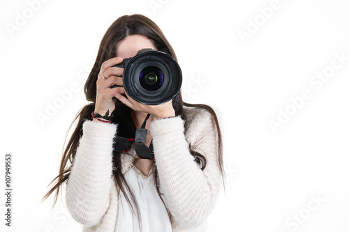 Pretty woman is a professional photographer with slr camera