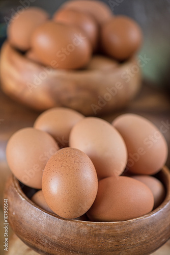 Fresh eggs at wooden plate 
