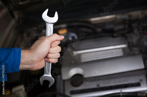 Wallpaper Mural Man in blue technician uniform going to repair for car maintenance  Torontodigital.ca