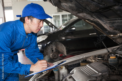 Man in blue technician uniform going to repair for car maintenance