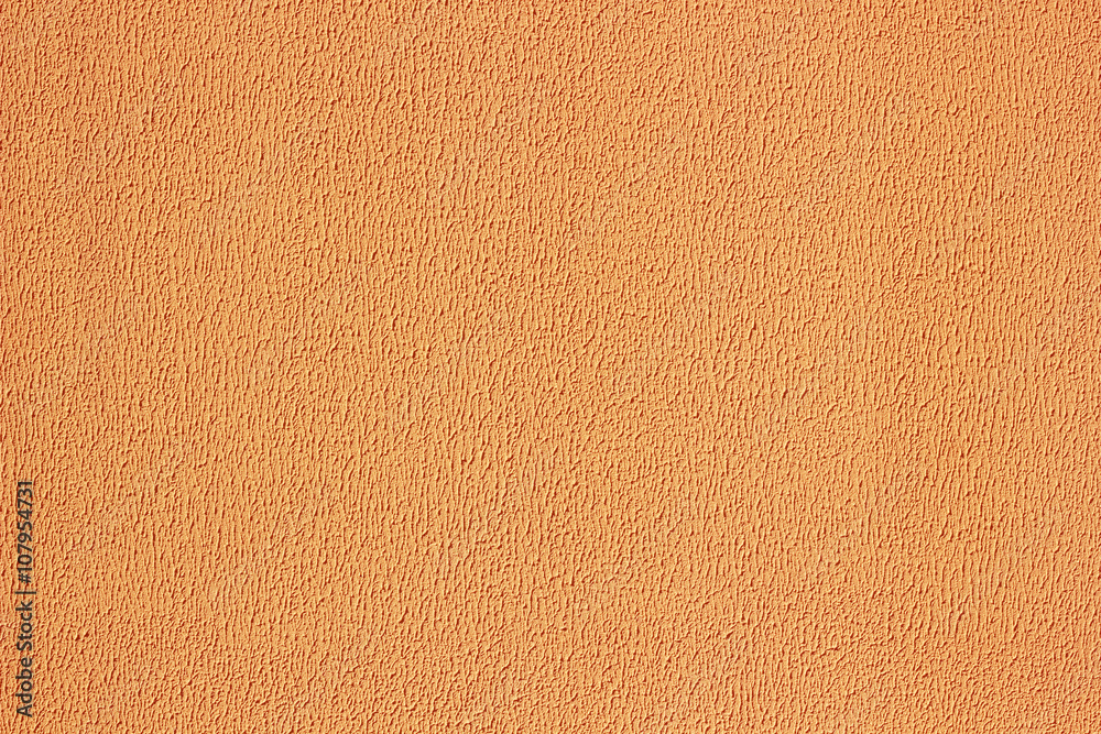 Fototapeta premium Plaster texture wall. Exterior orange stucco.