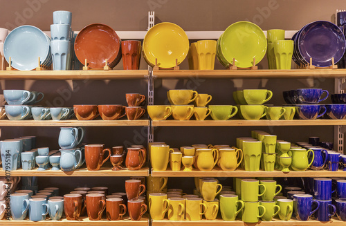 Store display of colorful tableware on the shelves.