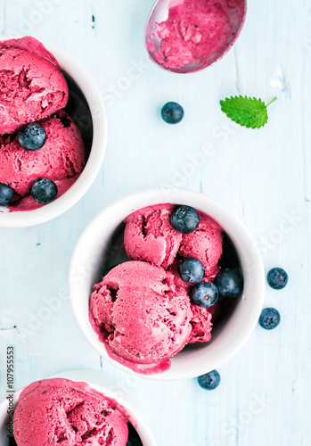 Konstfotografi Homemade blueberry ice cream scoops with fresh berries and mint leaves in cups o