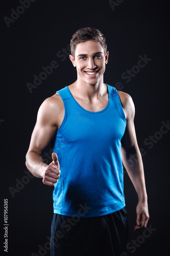Fitness boy on black background © Friends Stock
