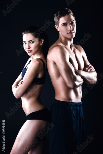 Fitness man and woman on black background