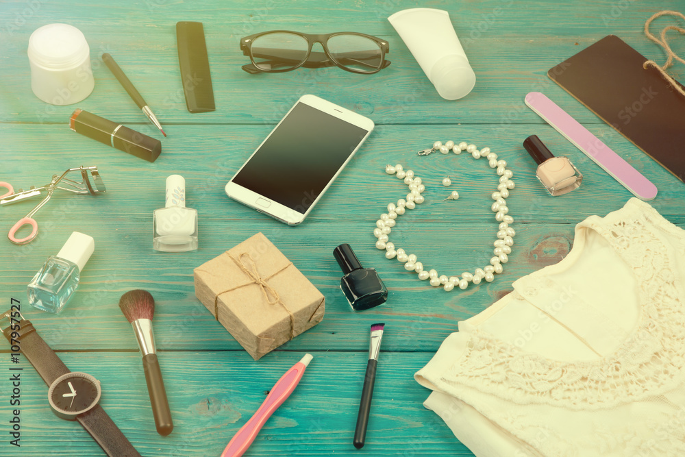 Sale concept - set of woman stuff on blue wooden background Sale concept - set of woman stuff on blue wooden background