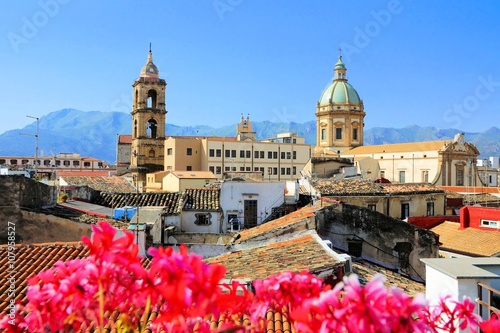 View over the rooftops and churches of Palermo, Sicily with vibrant flowers