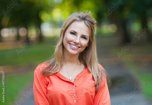 Surprised woman, delight, joy. Portrait of a woman on the street. Joy, positive emotions. Happy face. Open mouth.Green trees, summer, park